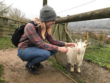 Girl and goat on farm in Bath